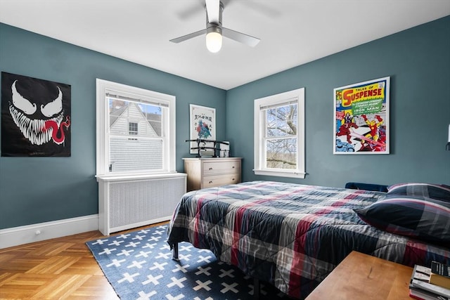 bedroom featuring baseboards, radiator heating unit, and ceiling fan