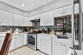 kitchen with appliances with stainless steel finishes, light countertops, and white cabinets