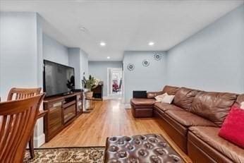 living room with light wood-style floors and recessed lighting