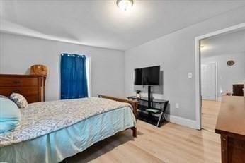 bedroom featuring light wood-type flooring and baseboards
