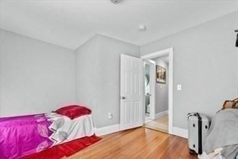 bedroom featuring wood finished floors and baseboards