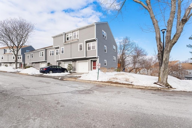 view of property featuring a garage and a residential view