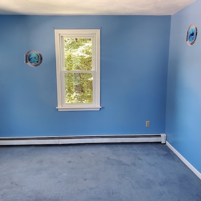 spare room with a baseboard radiator and carpet