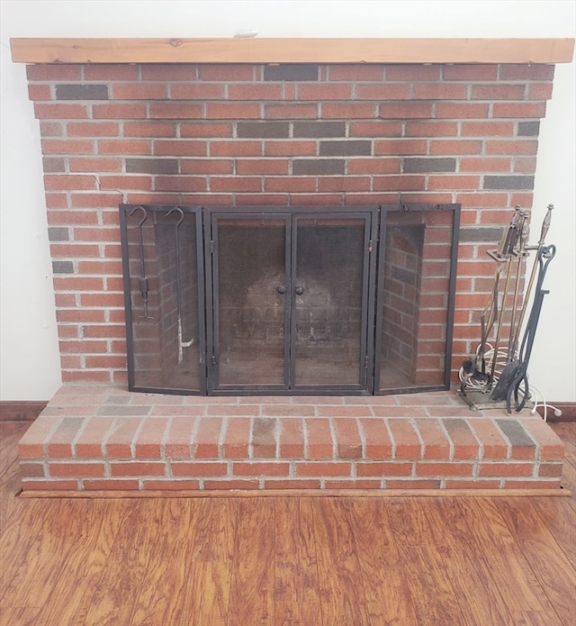 details with hardwood / wood-style floors and a fireplace