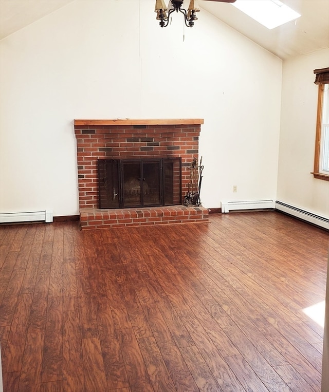 unfurnished living room with a baseboard heating unit, vaulted ceiling, hardwood / wood-style floors, and a brick fireplace