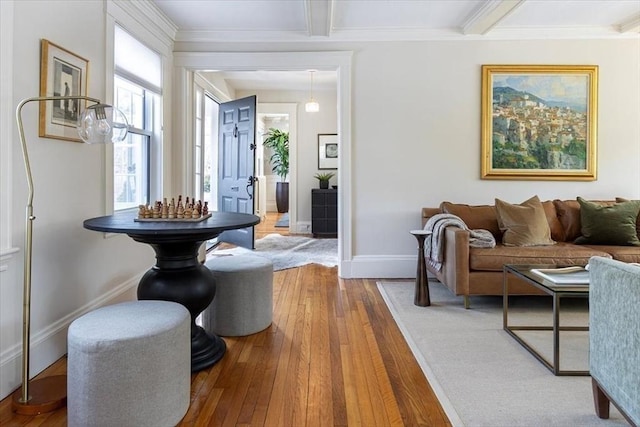 foyer featuring hardwood / wood-style flooring, crown molding, baseboards, and beam ceiling