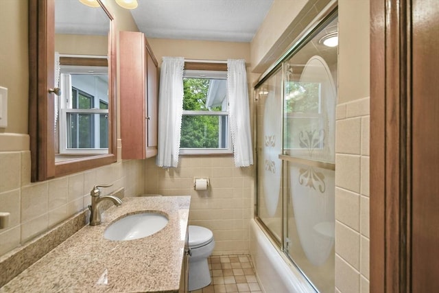 57 Strafford Rd, Westwood, MA 02090 - bathroom with toilet, vanity, enclosed tub / shower combo, tile walls, and tile patterned flooring