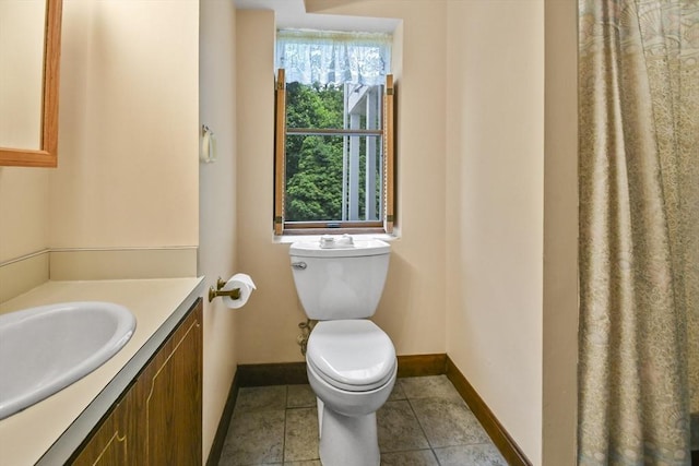 57 Strafford Rd, Westwood, MA 02090 - bathroom with baseboards, vanity, toilet, and tile patterned floors