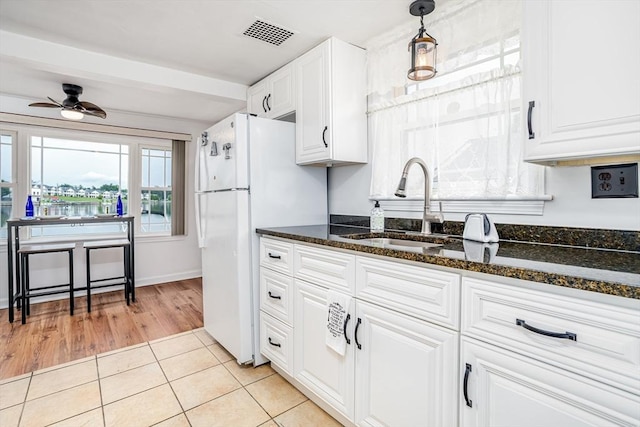 3 Lakeside Ave, Lunenburg, MA 01462 - kitchen with a ceiling fan, freestanding refrigerator, white cabinets, and dark stone countertops
