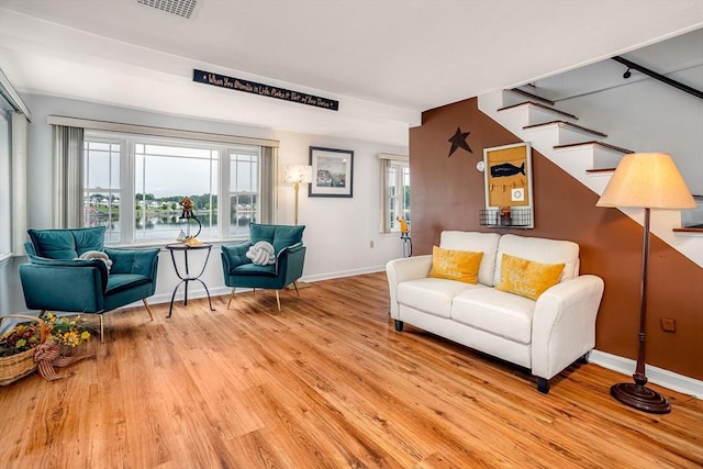 3 Lakeside Ave, Lunenburg, MA 01462 - living area with wood finished floors, stairway, baseboards, and a water view