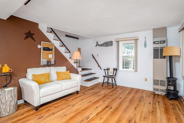 3 Lakeside Ave, Lunenburg, MA 01462 - living room with a heating unit, stairway, wood finished floors, a wood stove, and baseboards