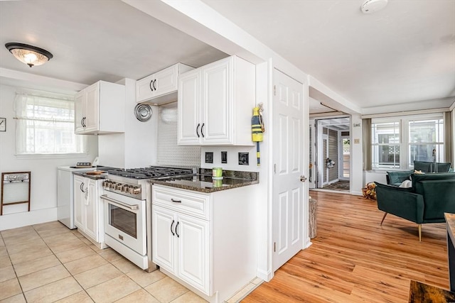 3 Lakeside Ave, Lunenburg, MA 01462 - kitchen featuring gas stove, washer / clothes dryer, white cabinets, and baseboards