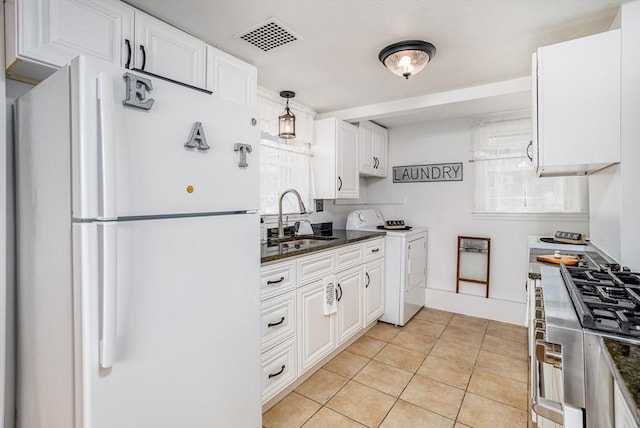 3 Lakeside Ave, Lunenburg, MA 01462 - kitchen with freestanding refrigerator, a sink, white cabinetry, and plenty of natural light