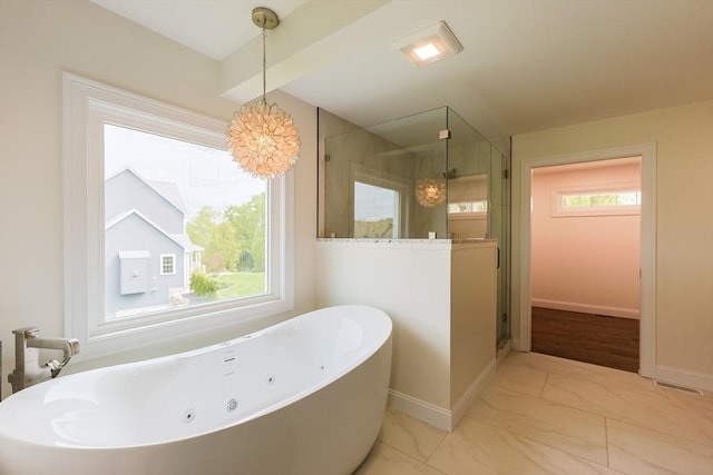 40 Blood Rd, Charlton, MA 01507 - bathroom with a freestanding tub, a stall shower, marble look tiles, and a chandelier