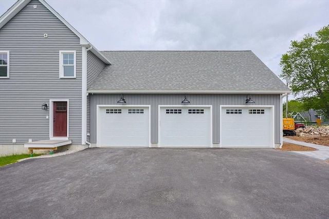 40 Blood Rd, Charlton, MA 01507 - view of side of home with a shingled roof, driveway, a garage, and board and batten siding