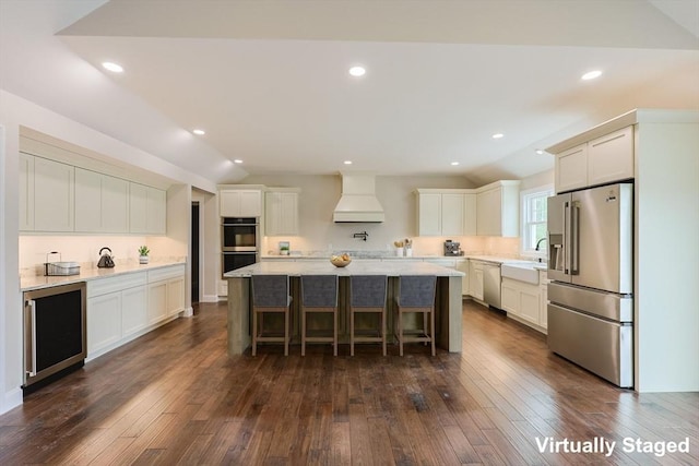 40 Blood Rd, Charlton, MA 01507 - kitchen with appliances with stainless steel finishes, premium range hood, wine cooler, lofted ceiling, and dark wood-style floors