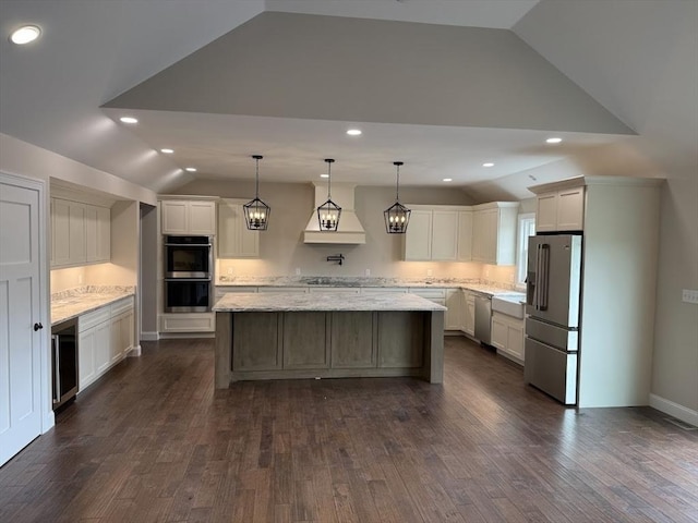 40 Blood Rd, Charlton, MA 01507 - kitchen featuring lofted ceiling, stainless steel appliances, a kitchen island, dark wood-style flooring, and light stone counters