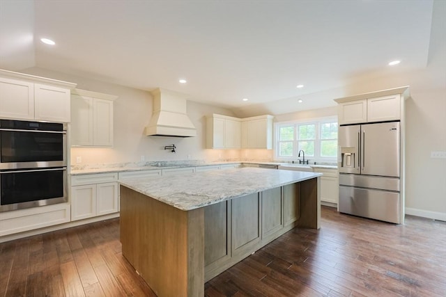 40 Blood Rd, Charlton, MA 01507 - kitchen featuring appliances with stainless steel finishes, premium range hood, a center island, white cabinetry, and recessed lighting