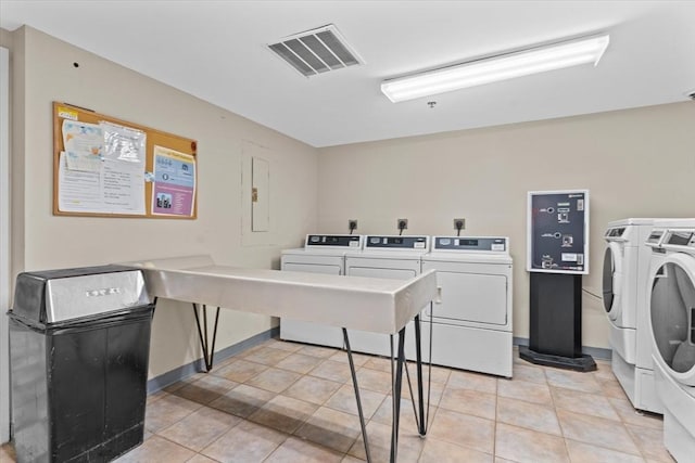 washroom with light tile patterned floors and washer and dryer