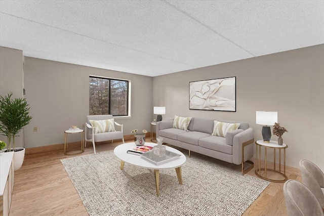 living room with light hardwood / wood-style floors and a textured ceiling