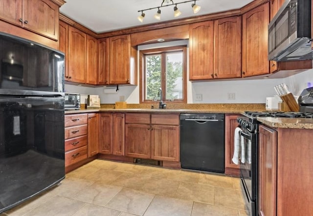 37 Saint Michaels Ave, Somerset, MA 02726 - kitchen with black appliances, a sink, brown cabinetry, light stone countertops, and light tile patterned floors