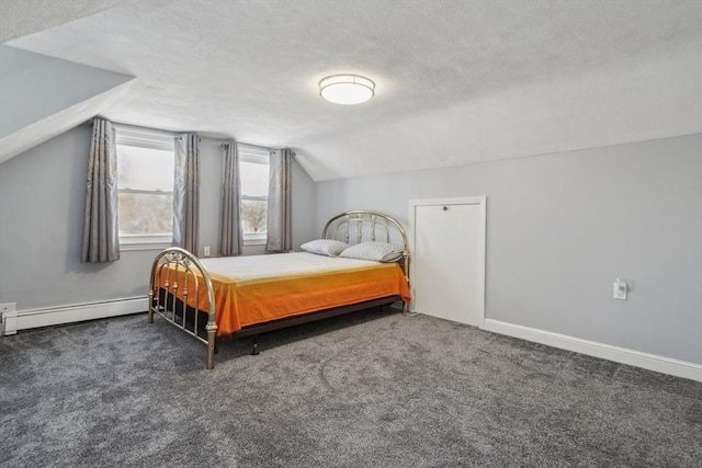 bedroom with lofted ceiling, dark carpet, a textured ceiling, and baseboard heating