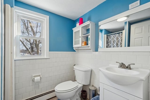 bathroom with a baseboard radiator, tile walls, vanity, and toilet