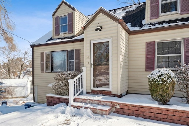 view of snow covered property entrance