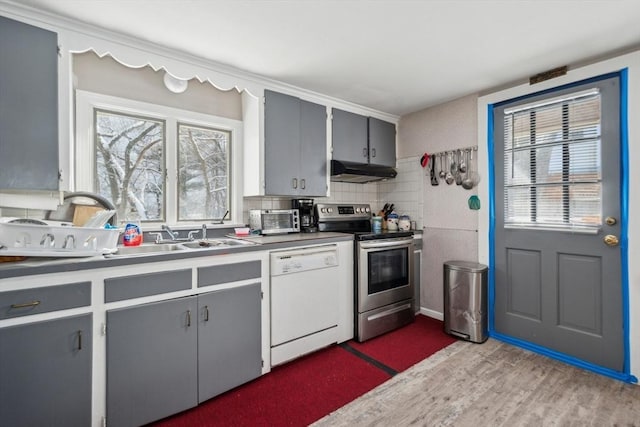 kitchen featuring gray cabinetry, decorative backsplash, stainless steel range with electric stovetop, white dishwasher, and light hardwood / wood-style flooring