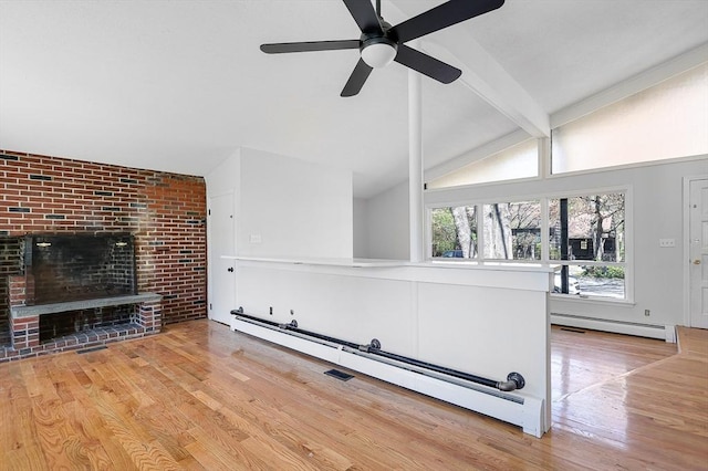 unfurnished living room featuring lofted ceiling with beams, baseboard heating, a ceiling fan, and wood finished floors