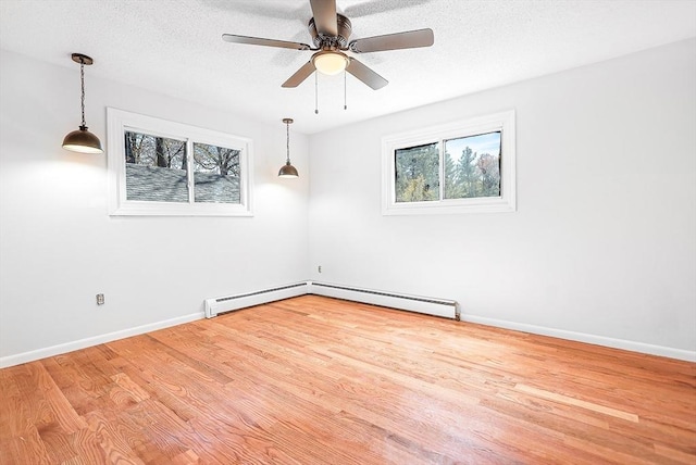 unfurnished room with a ceiling fan, wood finished floors, and a healthy amount of sunlight