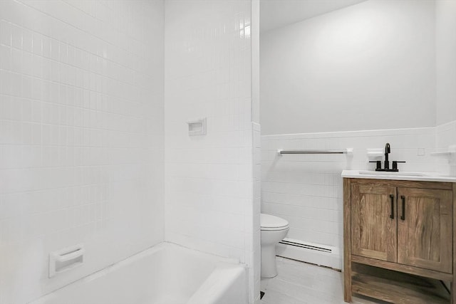 bathroom featuring baseboard heating, wainscoting, vanity, toilet, and tub / shower combination