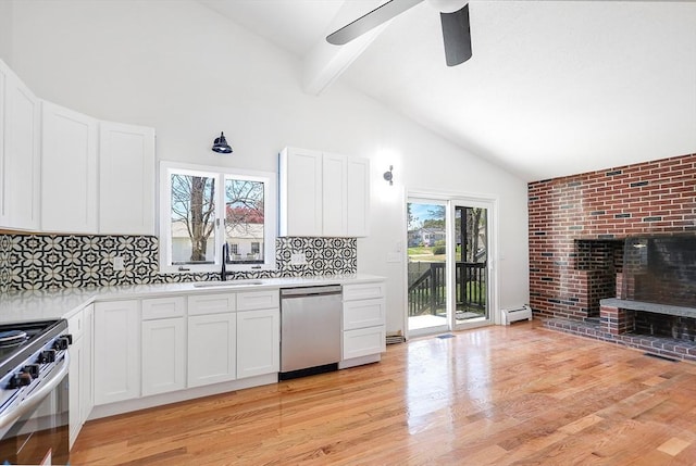 kitchen featuring appliances with stainless steel finishes, a sink, light countertops, beamed ceiling, and a baseboard heating unit