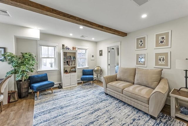 living area featuring recessed lighting, beam ceiling, visible vents, and wood finished floors