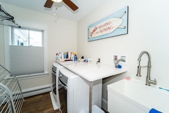 laundry area with dark wood-style flooring, a sink, laundry area, independent washer and dryer, and baseboards