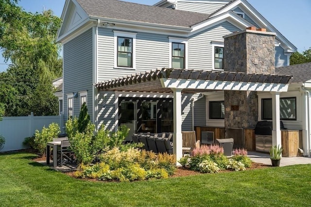 rear view of house featuring a shingled roof, fence, and a pergola