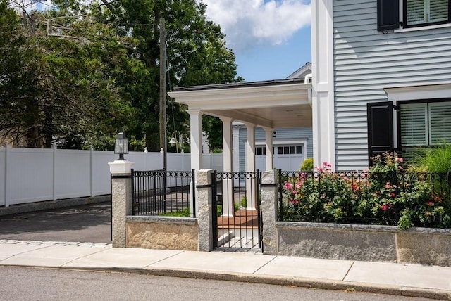 exterior space featuring a fenced front yard and a gate