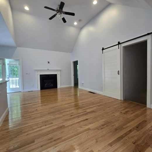 51 Alexandras Way, Brockton, MA 02301 - unfurnished living room featuring high vaulted ceiling, a ceiling fan, wood finished floors, a fireplace, and recessed lighting