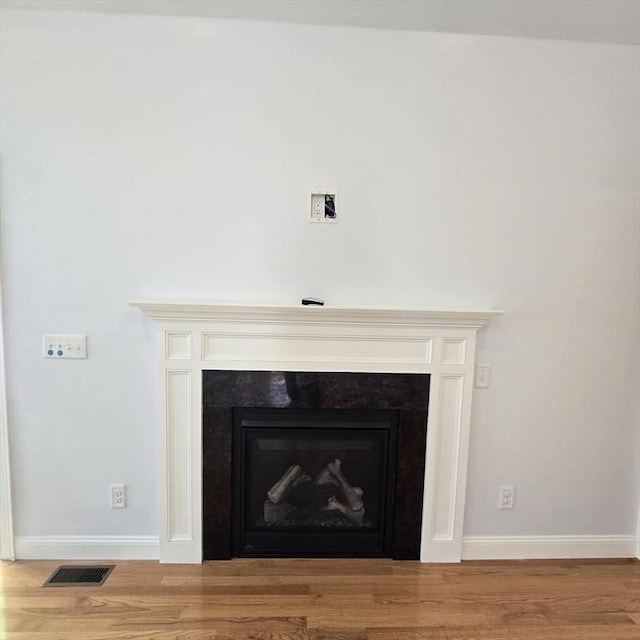 51 Alexandras Way, Brockton, MA 02301 - detailed view of a fireplace, wood finished floors, and baseboards