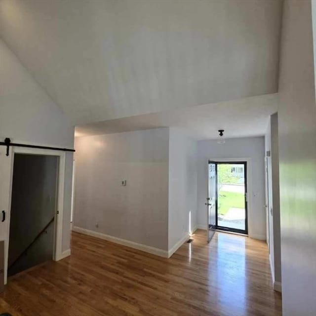 51 Alexandras Way, Brockton, MA 02301 - entrance foyer featuring a barn door, wood finished floors, baseboards, and lofted ceiling