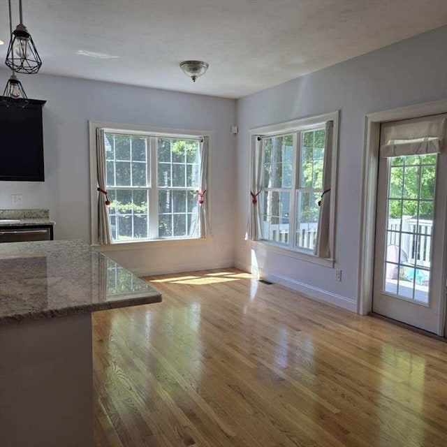 51 Alexandras Way, Brockton, MA 02301 - unfurnished dining area with wood finished floors, healthy amount of natural light, and baseboards