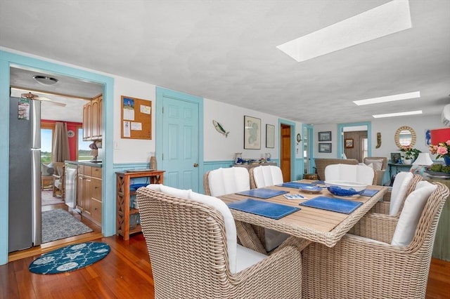 16 Gulls Cove Rd, Yarmouth, MA 02673 - dining room featuring a skylight, wood finished floors, and wainscoting