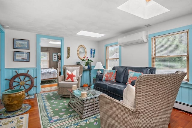 16 Gulls Cove Rd, Yarmouth, MA 02673 - living room with a skylight, a wall mounted air conditioner, wood finished floors, wainscoting, and a baseboard radiator
