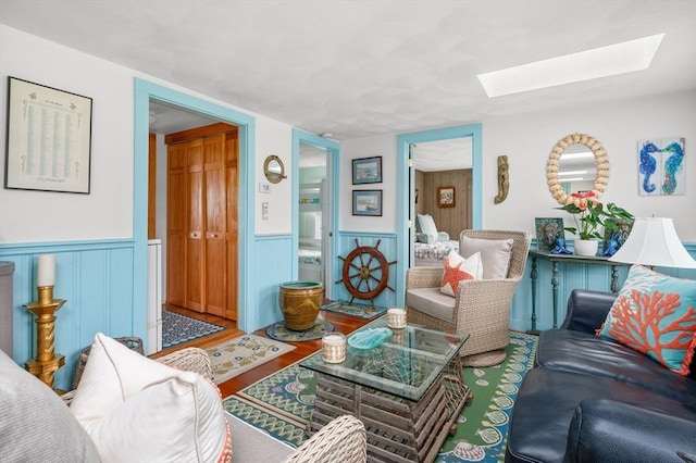 16 Gulls Cove Rd, Yarmouth, MA 02673 - living room featuring a skylight, wood finished floors, and wainscoting