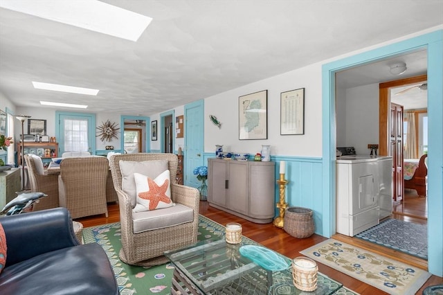 16 Gulls Cove Rd, Yarmouth, MA 02673 - living room with a skylight, wood finished floors, separate washer and dryer, and a wainscoted wall