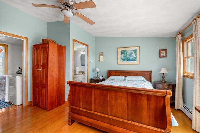 16 Gulls Cove Rd, Yarmouth, MA 02673 - bedroom with light wood-style flooring, a baseboard radiator, ensuite bath, and washing machine and dryer