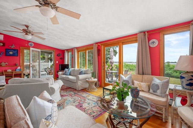 16 Gulls Cove Rd, Yarmouth, MA 02673 - living room featuring healthy amount of natural light, vaulted ceiling, wood finished floors, and a ceiling fan