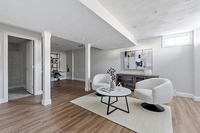65 Palmetto Dr Unit 65, Bellingham, MA 02019 - living area featuring baseboards, light wood finished floors, and decorative columns