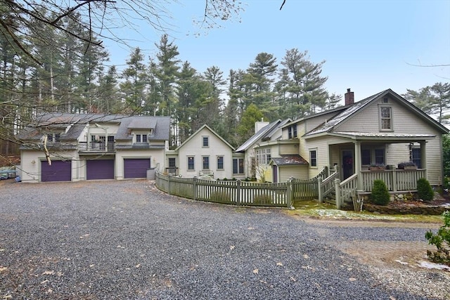 view of front facade with covered porch and a garage