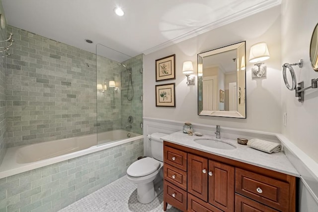 full bathroom with crown molding, tile patterned flooring, tiled shower / bath combo, toilet, and vanity